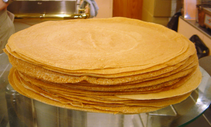 These thin pancakes are beloved enough that France celebrates National Crepes Day on February 2nd. You can eat them for breakfast or as dessert. In addition, if you’re in the mood for something sweet, you can get yourself some crepes filled with strawberries and cream or Nutella. On the other hand, if you’re looking for a savory snack, you can order them with such fillings as chicken, cheese, mushrooms, ratatouille or eggs.
