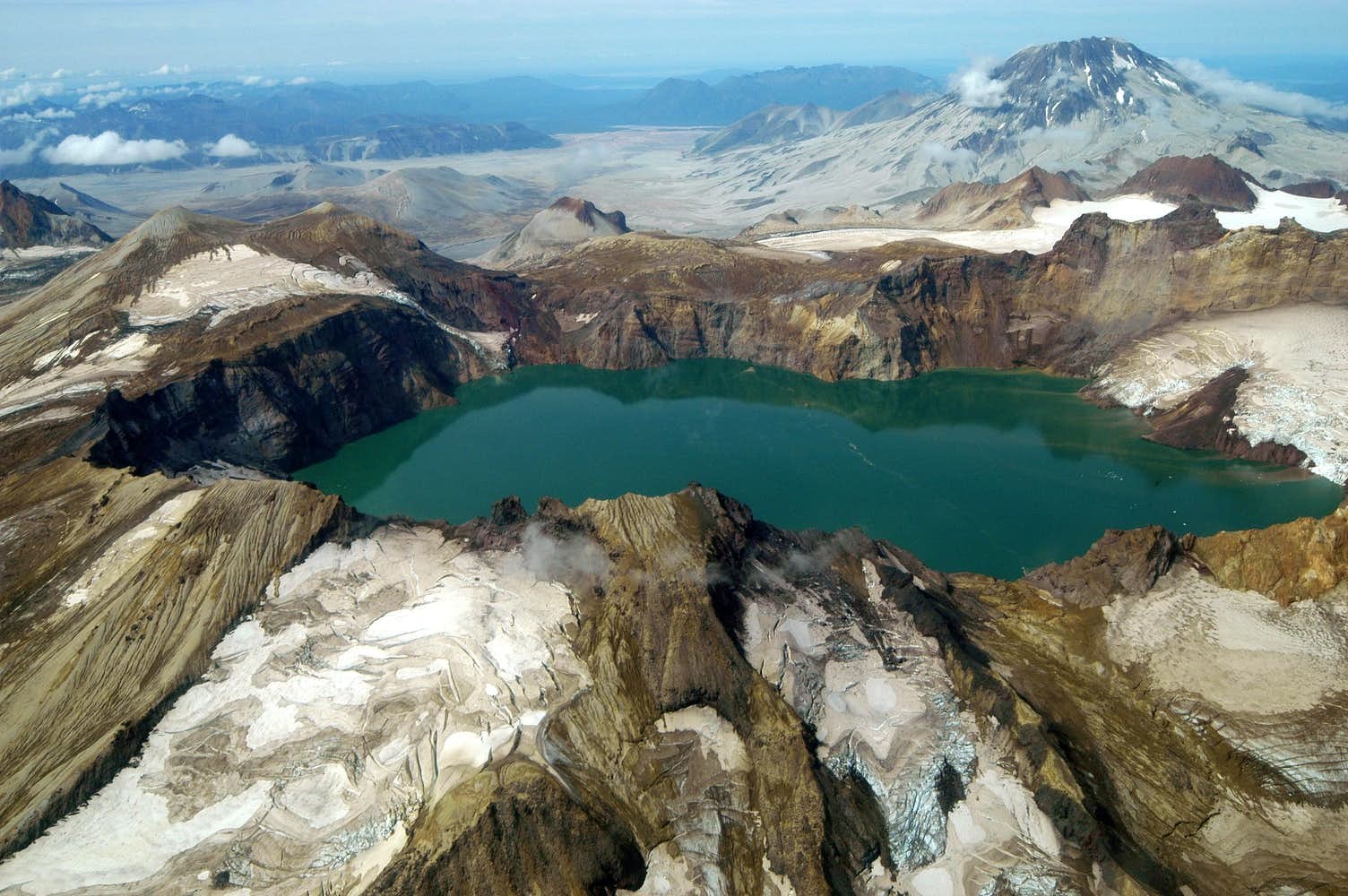 This amazing crater lake on the snowy mountain tops looks like a winter wonderland. It was formed in 1912 during the Novarupta eruption.