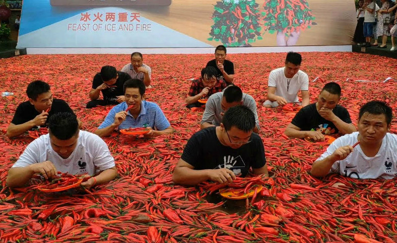Let’s start off with a blast!  How many flaming-hot chili peppers would you be willing to ingest to win a gold coin? If it’s anything less than 50, you may as well just give up right away. Tang Shuaihui from Hunan, somehow managed to down 50 peppers in 68 seconds, which allowed him to win the main prize – 24-carat gold coin. I do not want to find out what his toiled looked like after that ordeal.